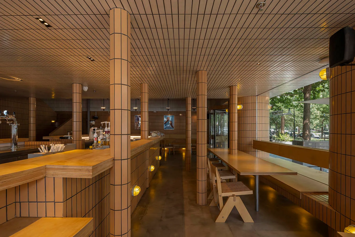 Interior of a modern restaurant featuring a wood-themed design.