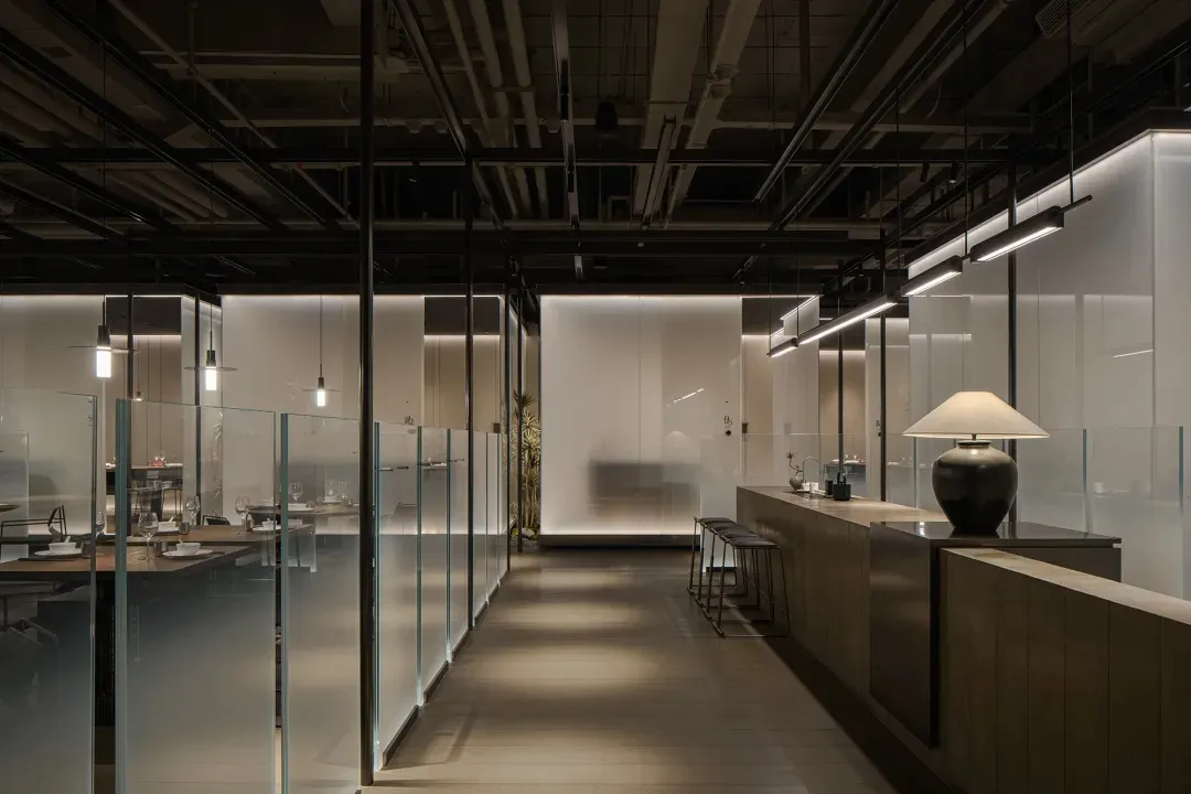 Industrial-themed restaurant featuring glass, steel, and wooden elements
