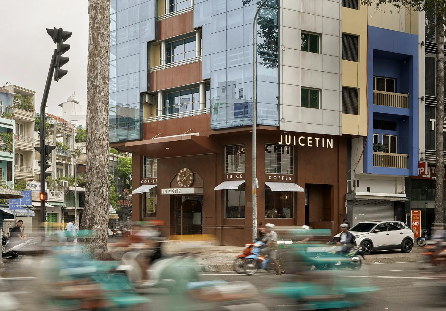 Modern exterior of a coffee shop featuring glass and concrete materials.