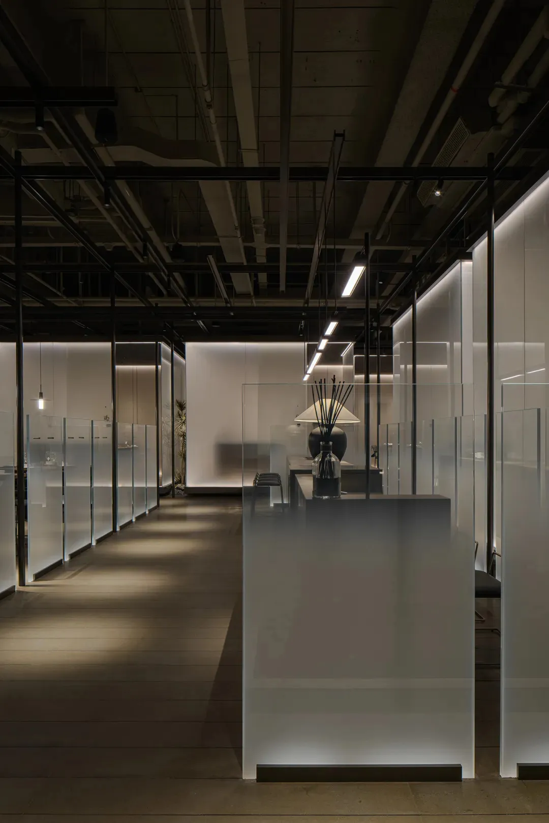 Modern office space featuring frosted glass panels and minimalist design.