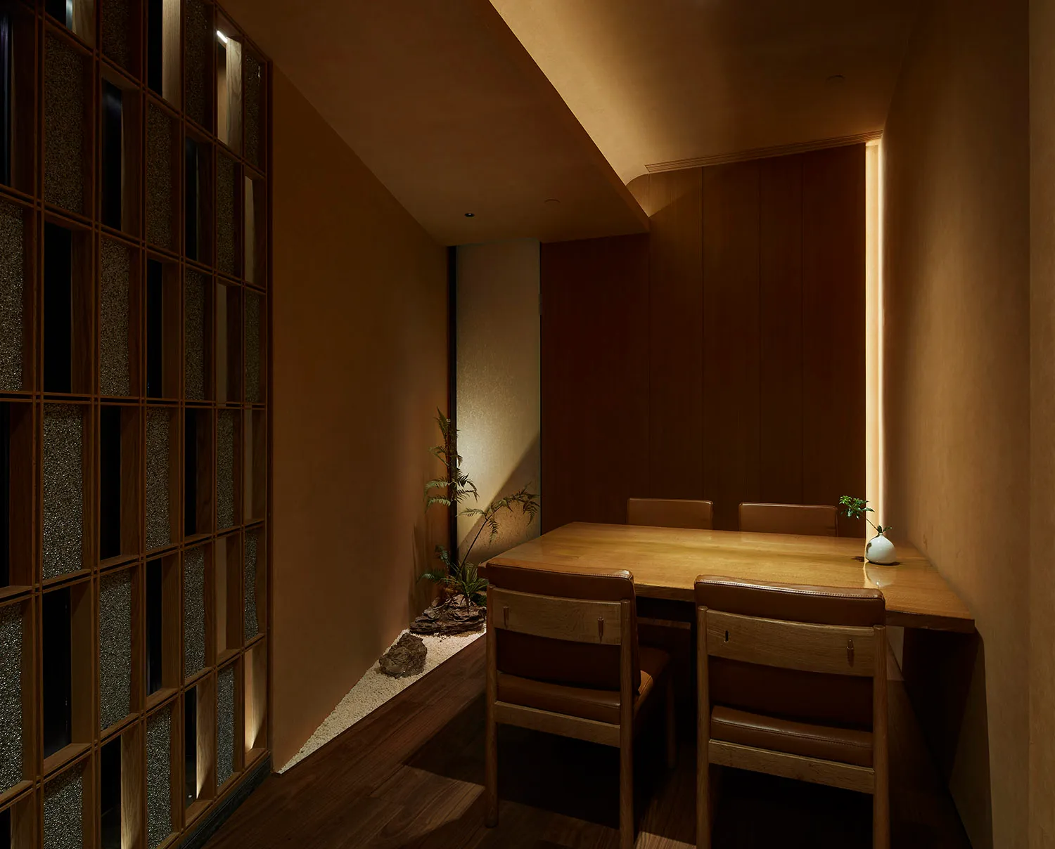 A cozy modern restaurant interior with wooden tables, chairs, and a floor-to-ceiling window.