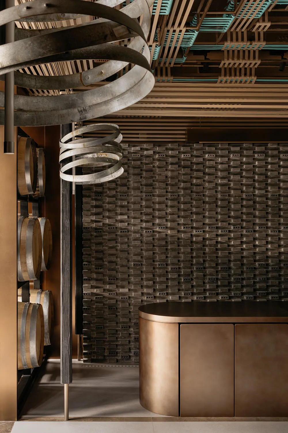 Industrial-style bar area with metallic elements and a textured wall.