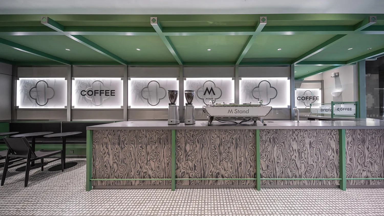 Interior view of a modern coffee shop featuring a counter made of light-colored wood.