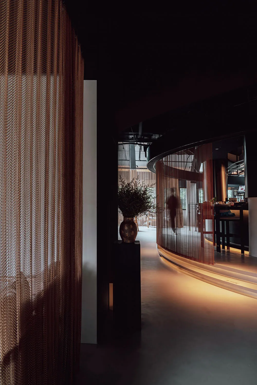 A modern-looking restaurant interior with glass curtains and a cozy ambiance.