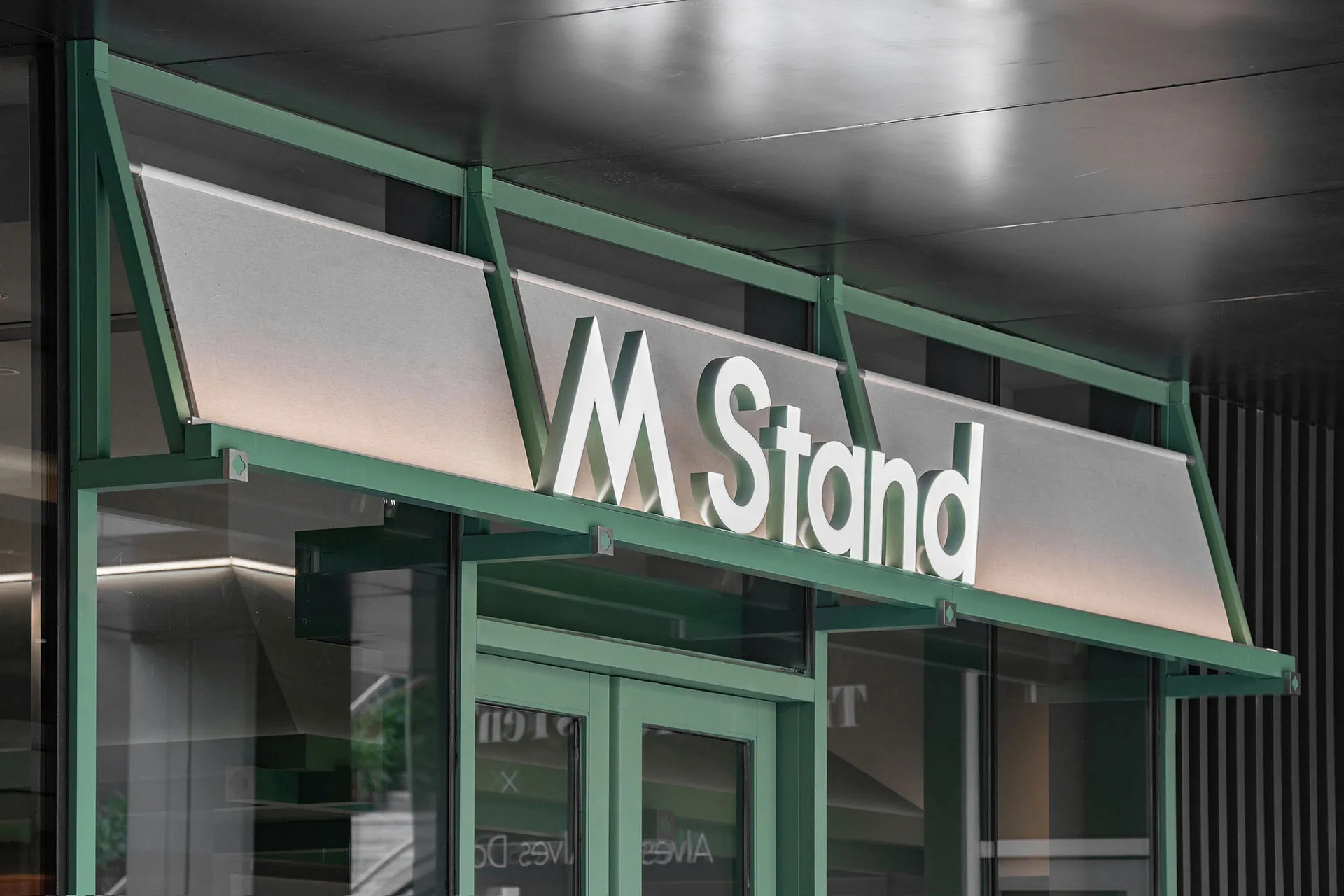 Modern retail storefront sign featuring metallic material