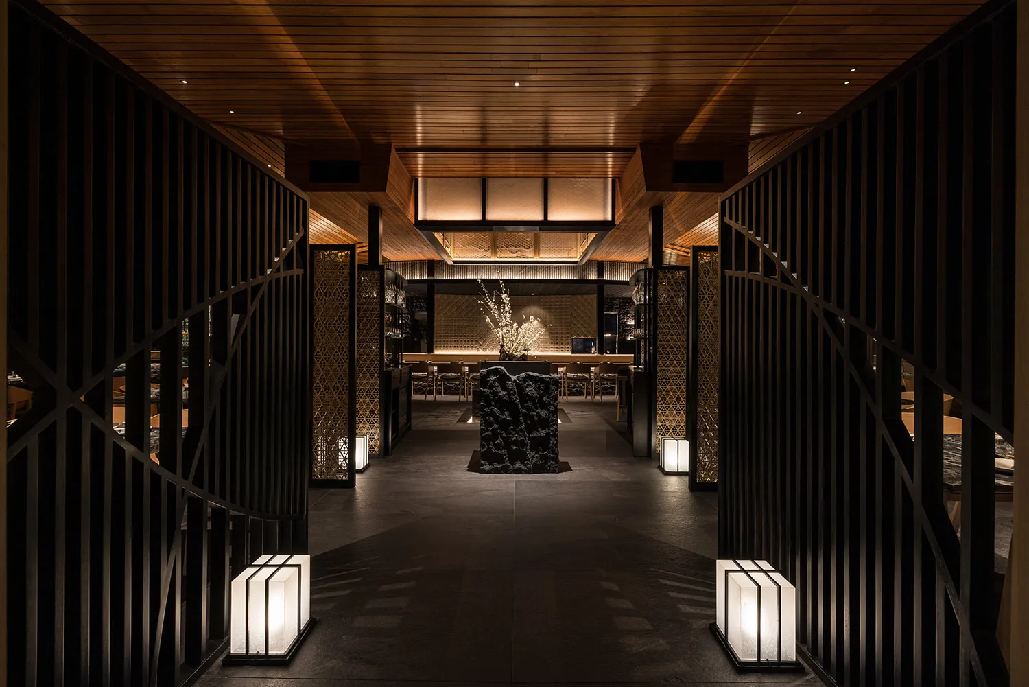 A modern restaurant interior featuring wooden materials and contemporary design elements.