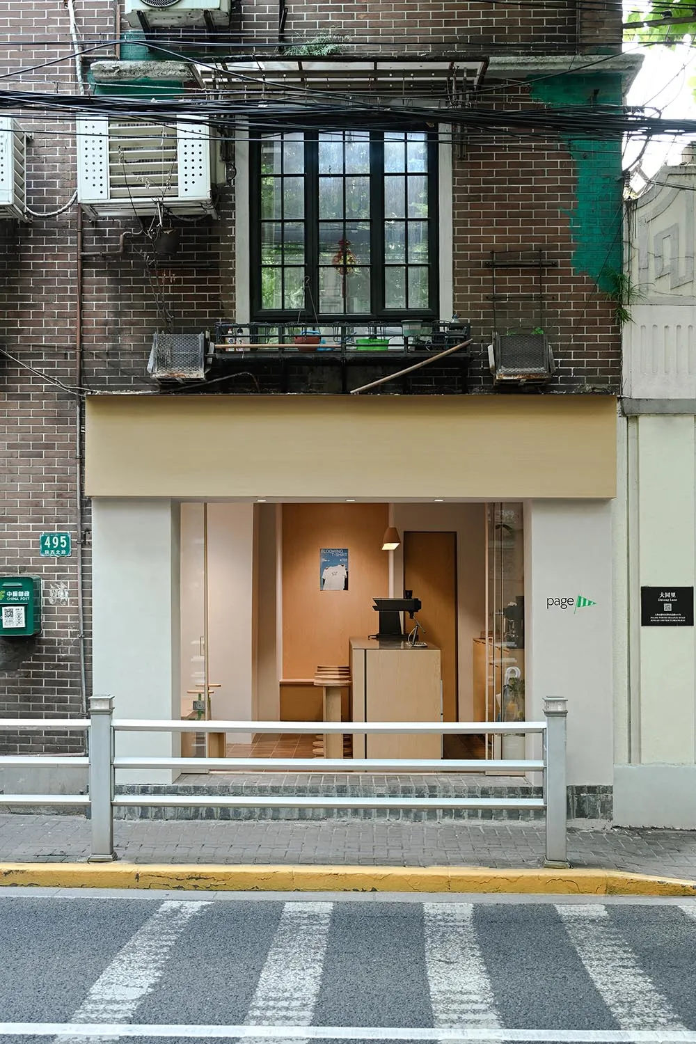 從街上看一間混凝土外牆的店面照片。