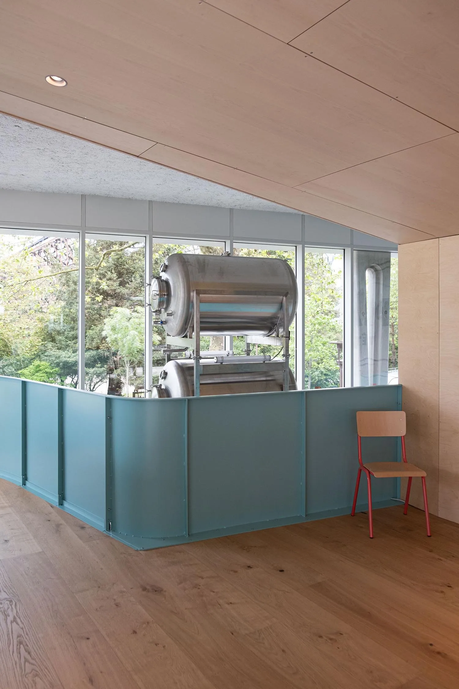 Modern brewery interior featuring stainless steel tanks in a contemporary setting.