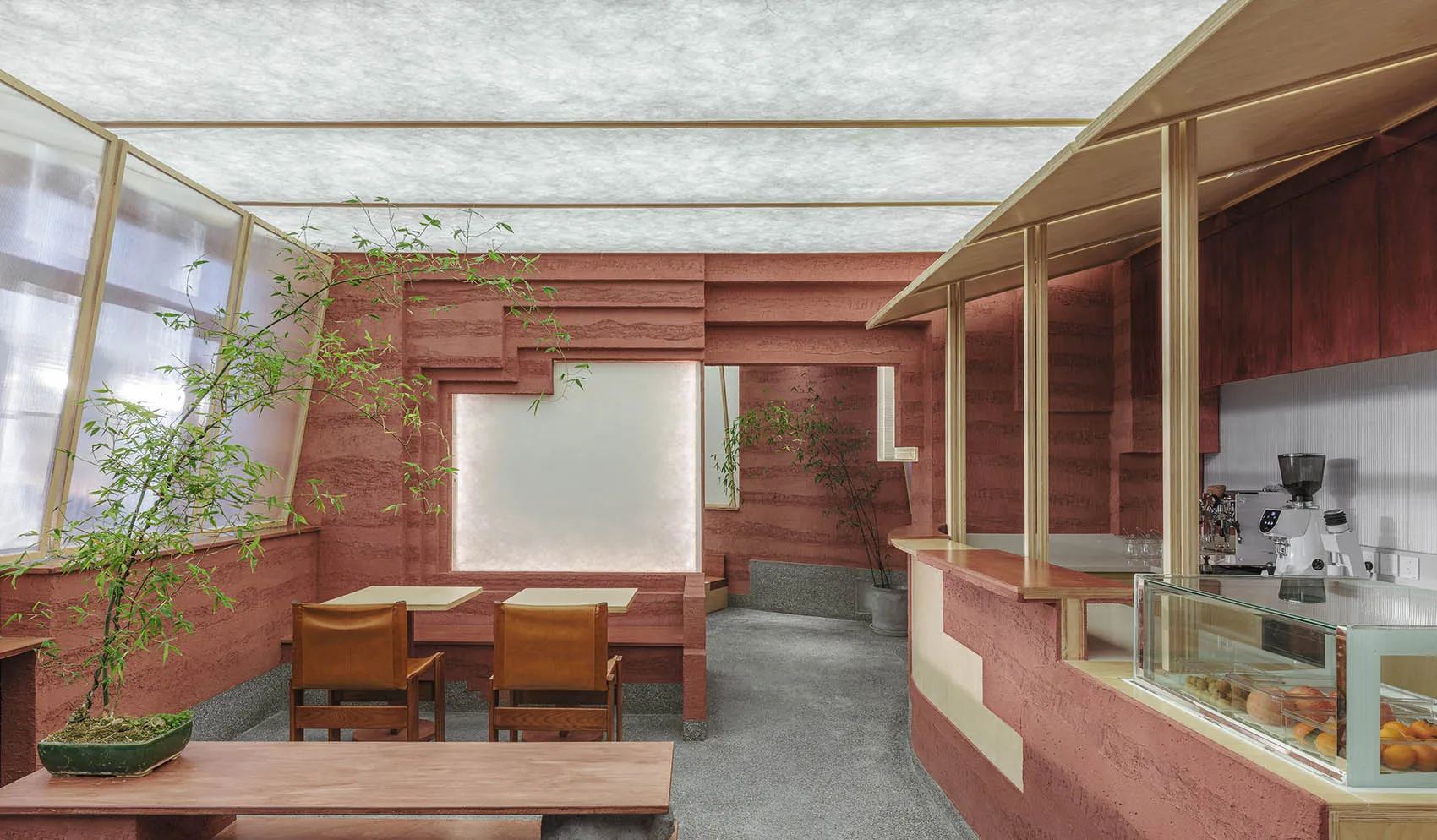 A modern coffee shop with terracotta walls and a minimalist design.