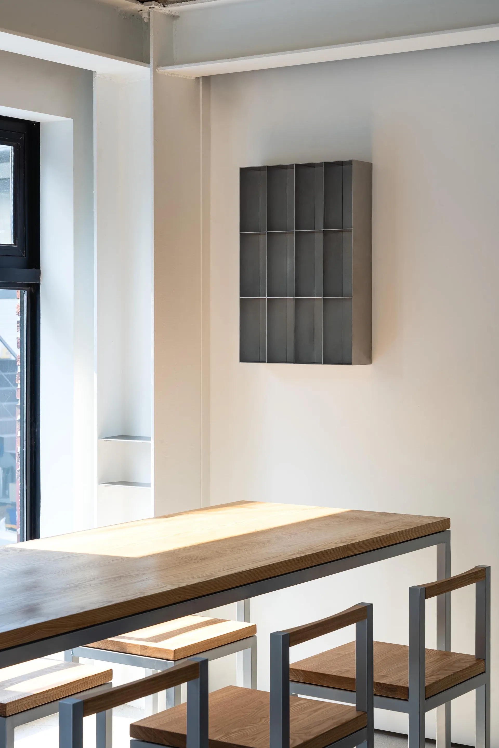 Industrial-style interior with wooden tables and metal chairs, minimalist design, modern space