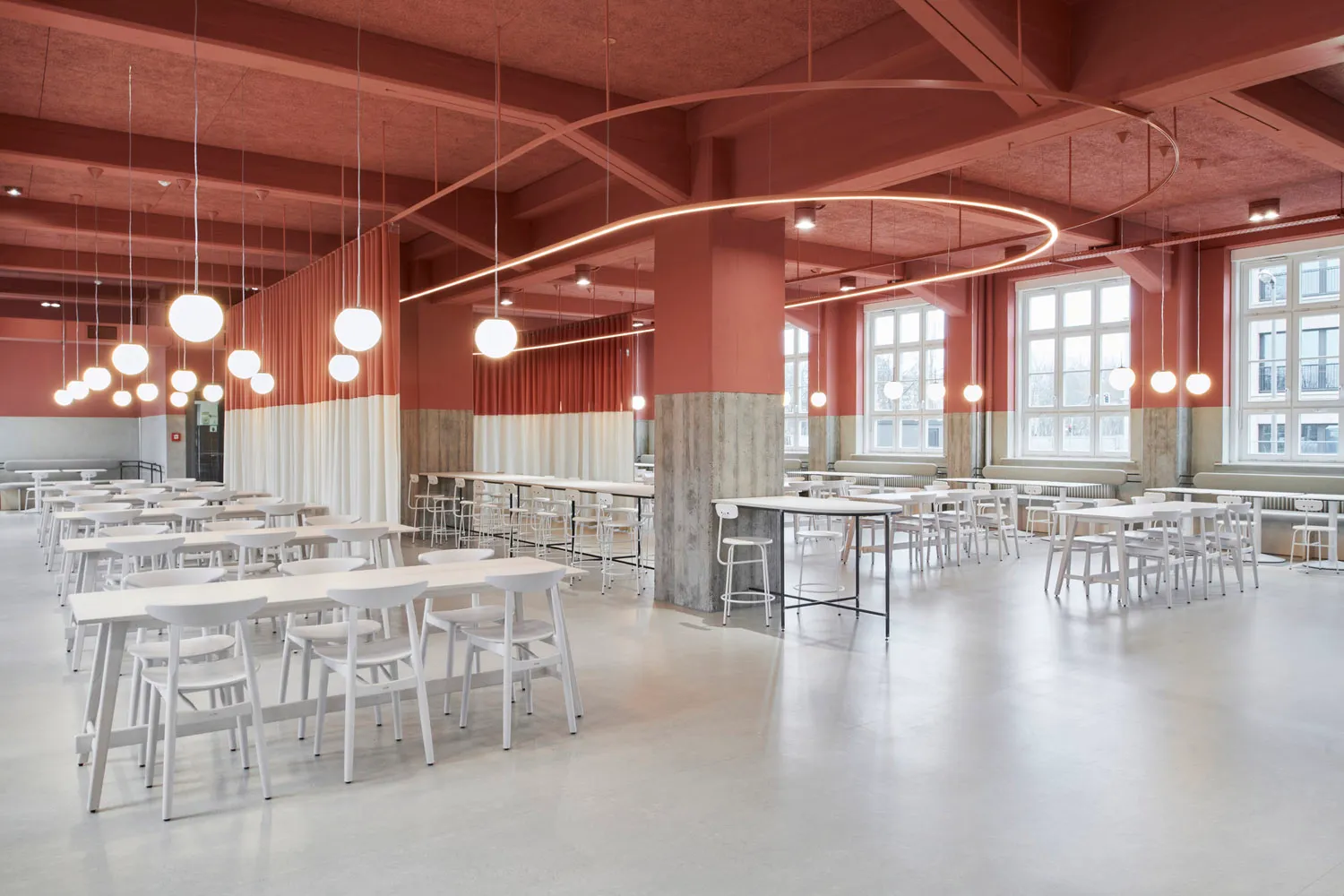 A spacious commercial canteen with modern design elements of concrete and terrazzo