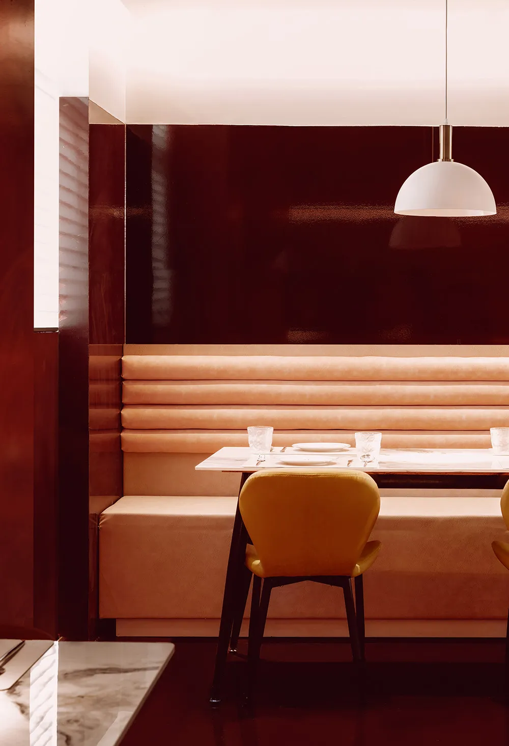 Modern restaurant booth seating with fabric seating and a polished floor.