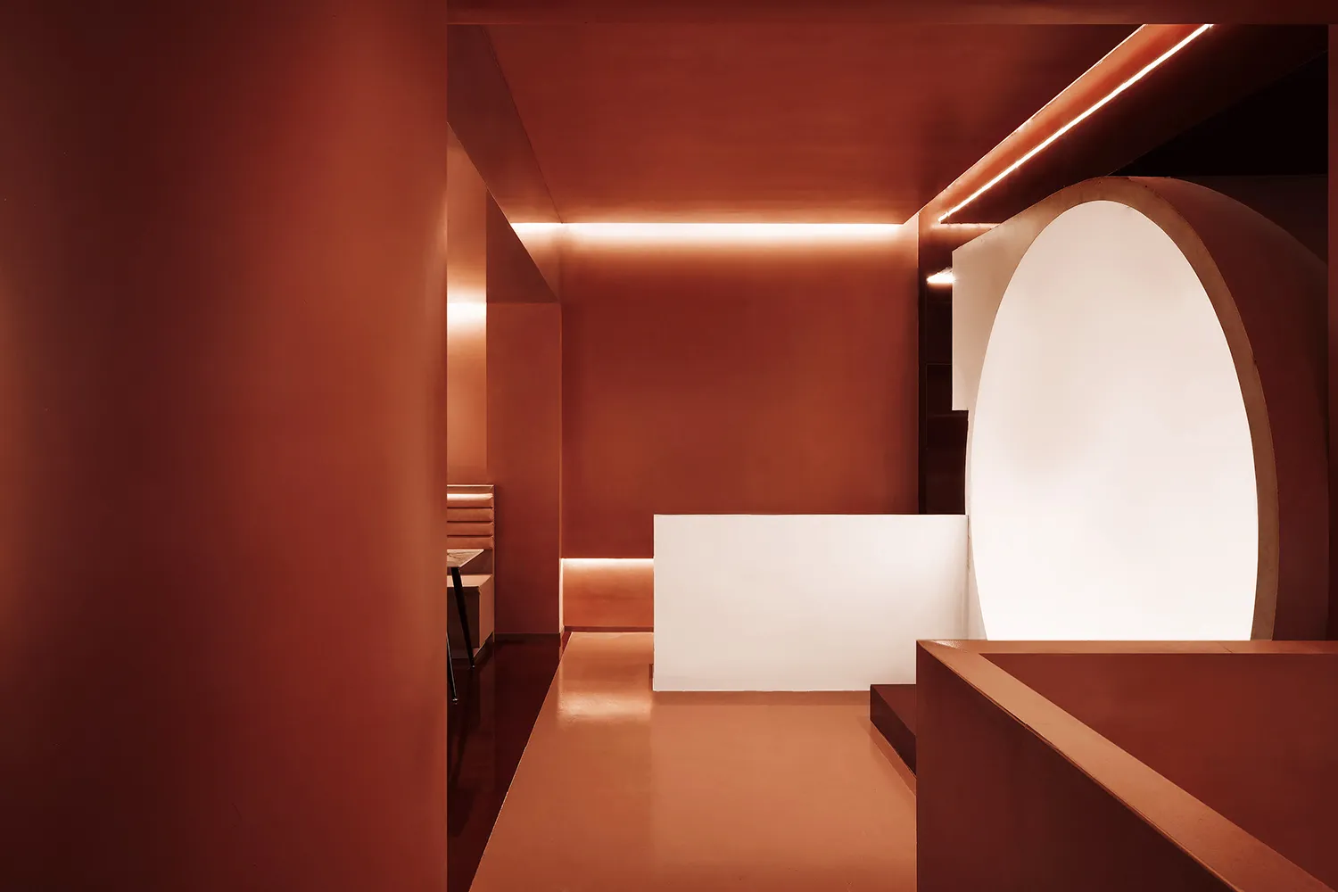 Terrazzo interior of a modern restaurant with a white archway and minimalist design.