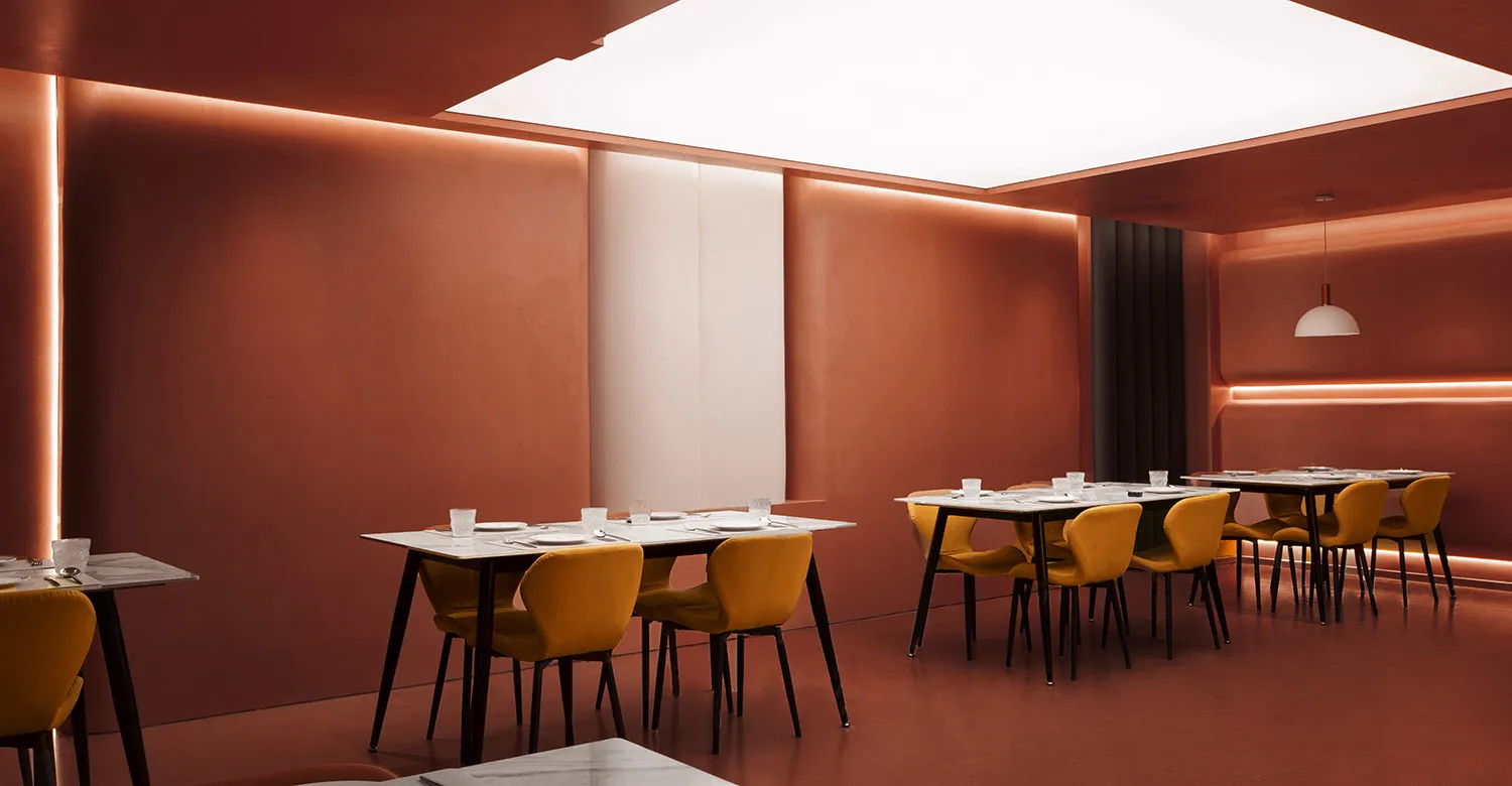 A modern restaurant interior with marble and concrete finishes.