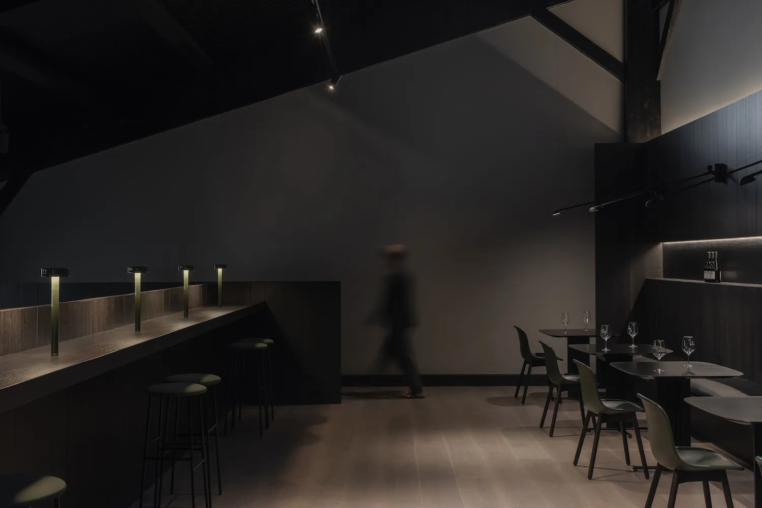 Modern industrial restaurant interior with concrete and wood elements.