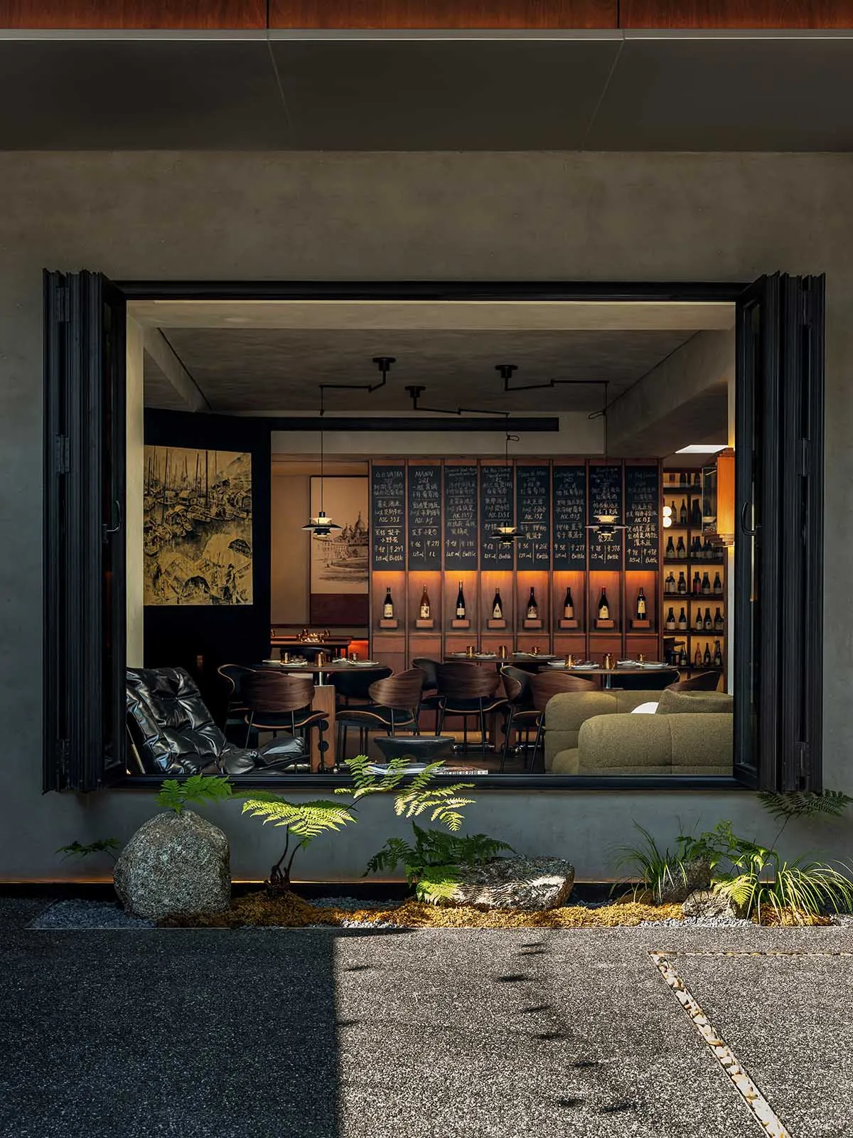 Modern restaurant bar with wooden furniture and concrete walls, featured in a Brewbar & Kitchen setting.