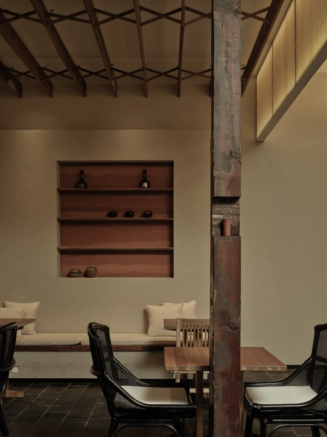 Modern restaurant interior with wooden beams, fabric textiles, and clay decor