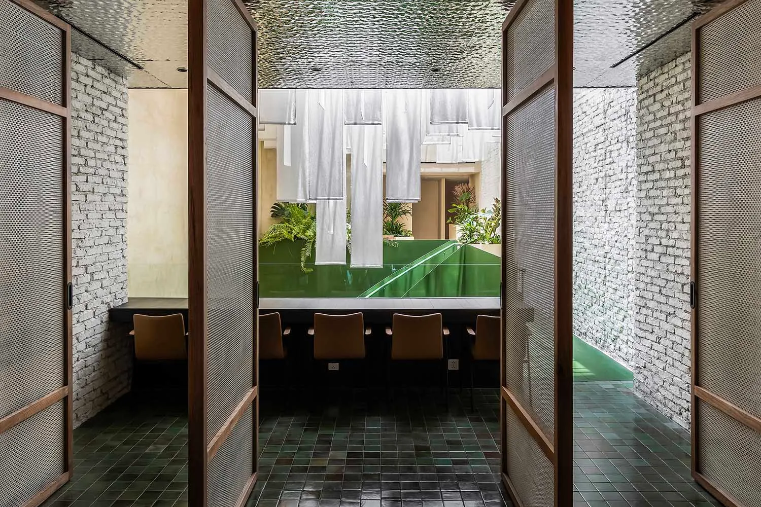 Contemporary restaurant interior with tiled flooring and exposed brick walls