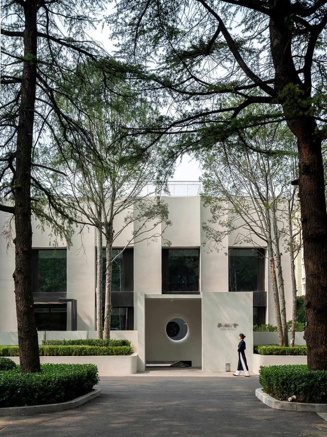 A modern office building with a minimalist design, constructed primarily of concrete materials.