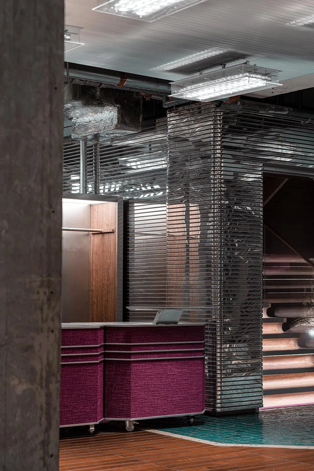 Purple reception desk with glass and metal elements, modern industrial design