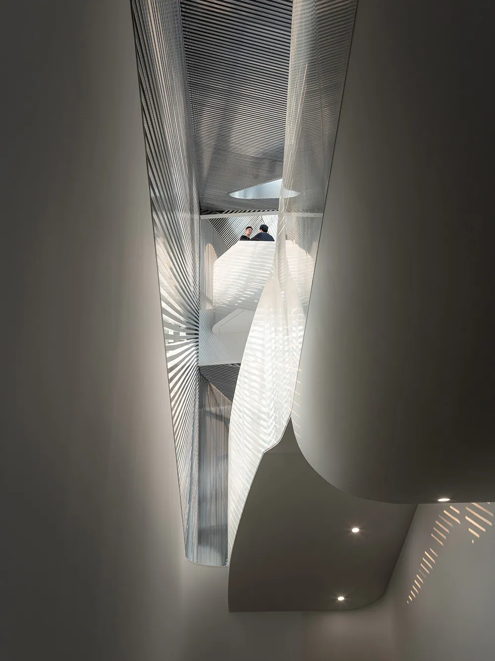 Modern interior featuring a metallic ceiling with geometric patterns.