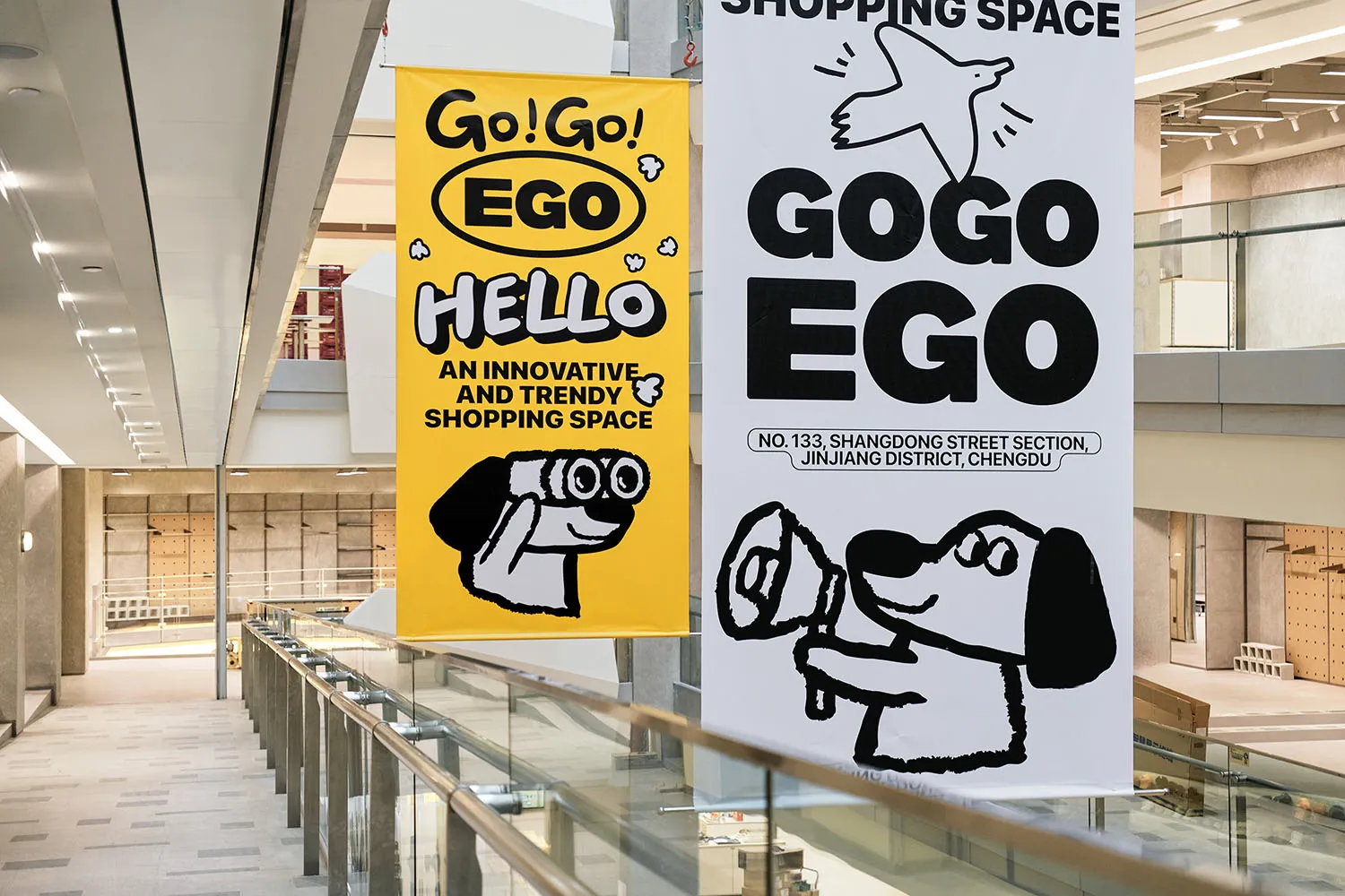 Gogo Ego banners displaying promotional text and a cartoon character in a shopping center setting.
