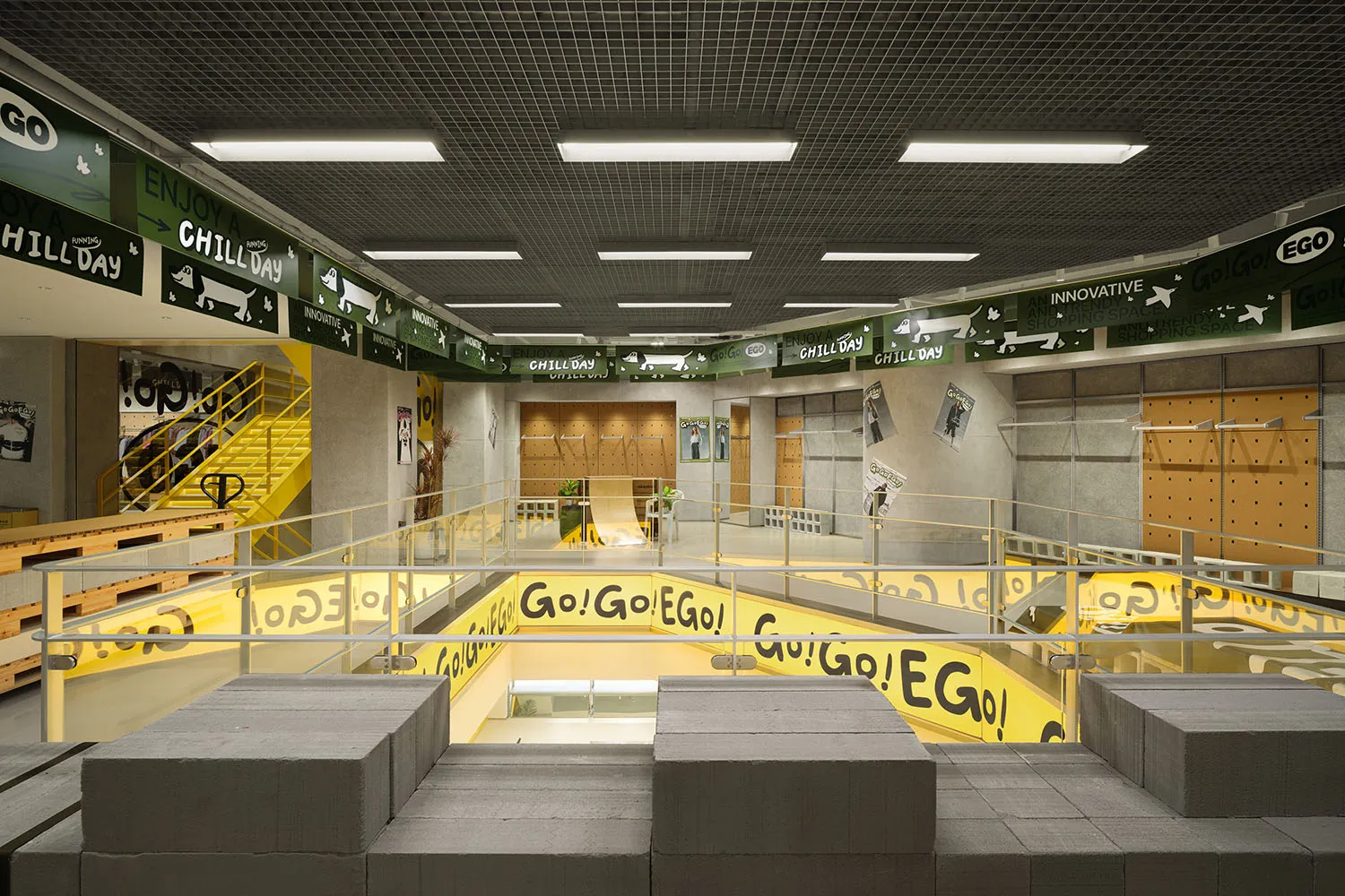 Modern industrial retail space featuring glass elements and concrete flooring.
