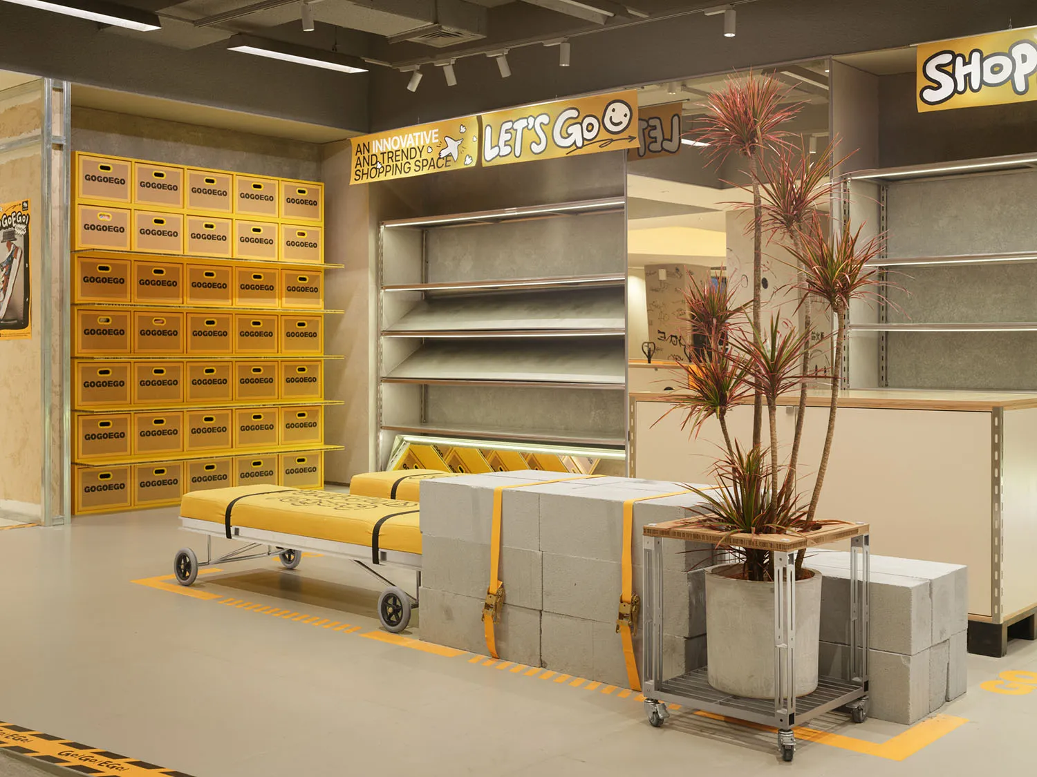 A modern retail store featuring concrete walls and yellow accents.