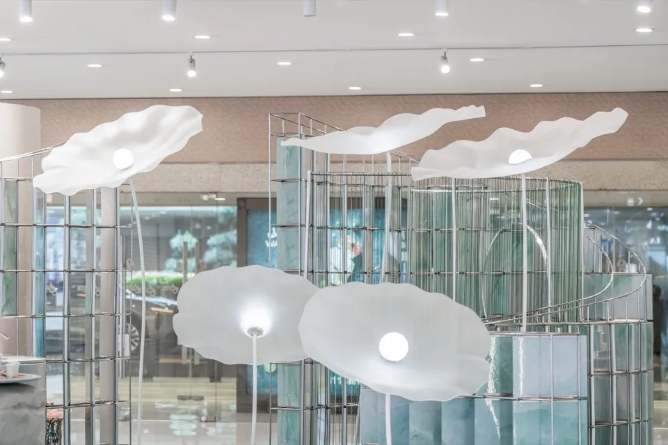 A glass storefront for a retail space with organic, cloud-like shapes.