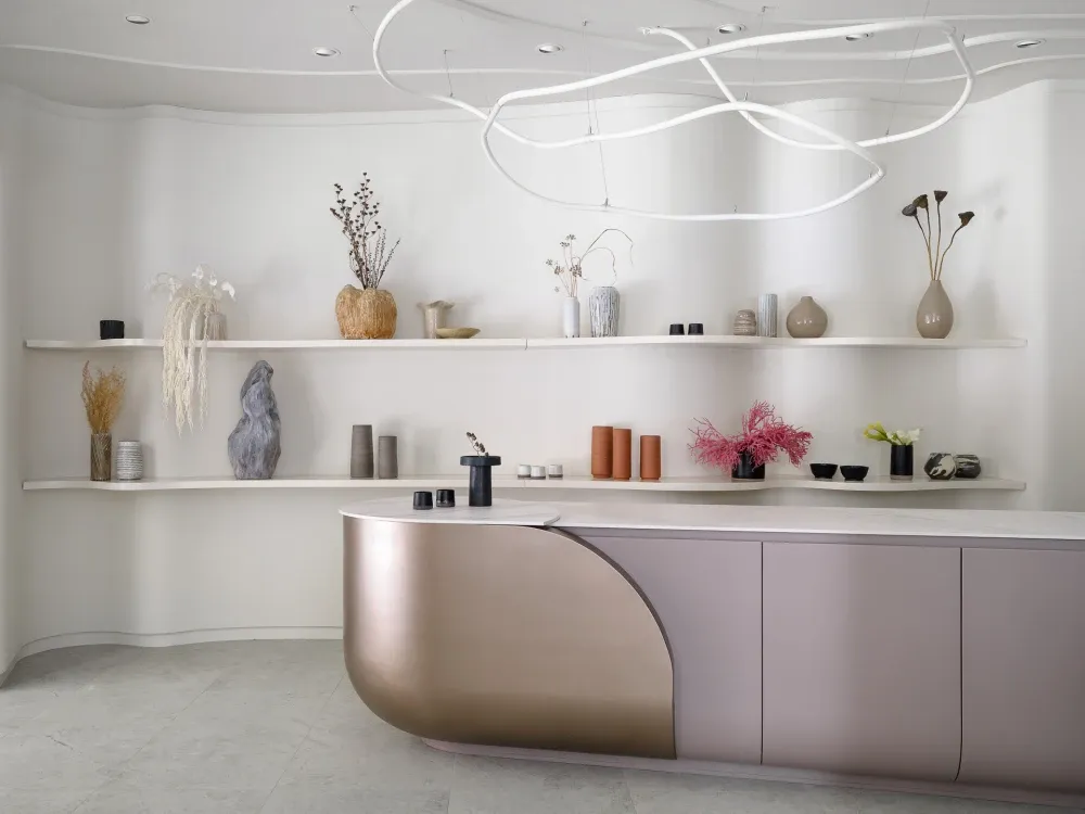 A modern reception desk made of metal and marble materials.