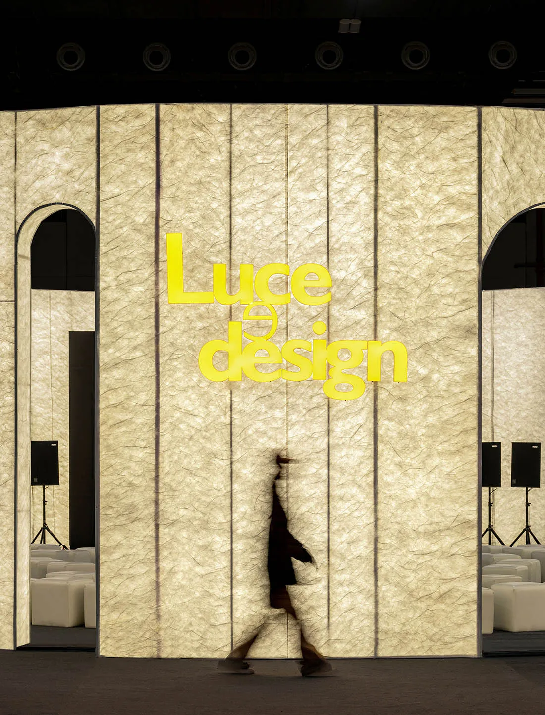 A minimalist retail storefront featuring textured glass panels and a sign that reads 'Luce Design'.