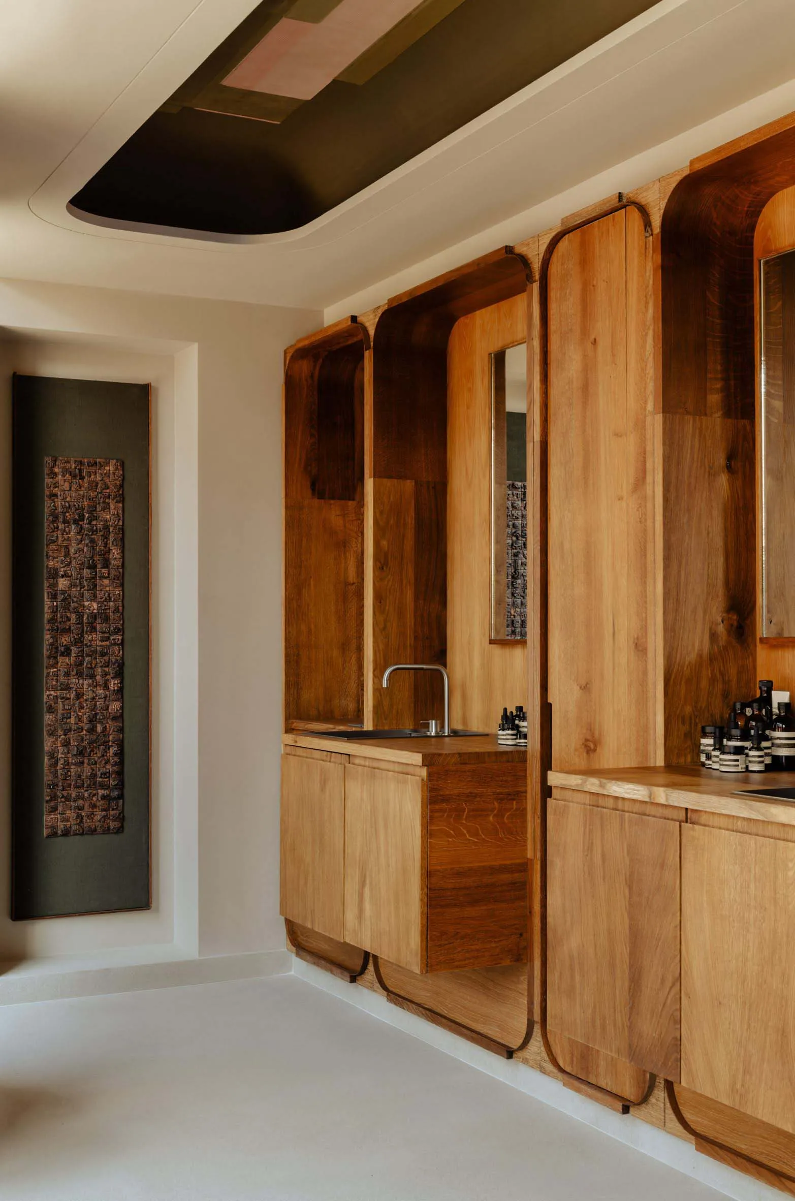 Modern, minimalist bathroom featuring wood accents and a sleek design.