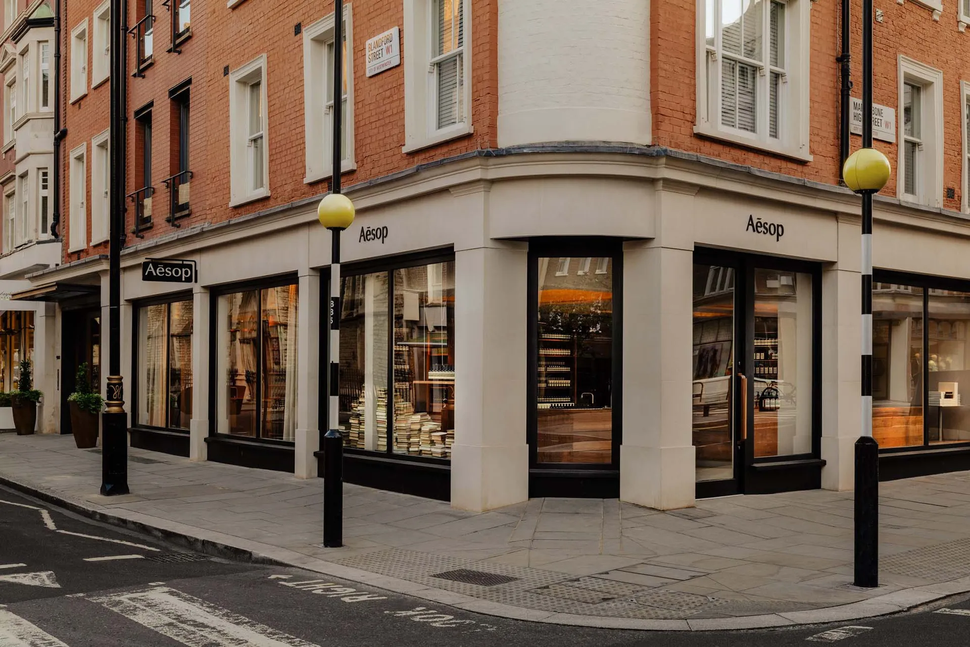 A modern retail storefront with glass windows, stone accents, and wooden materials.