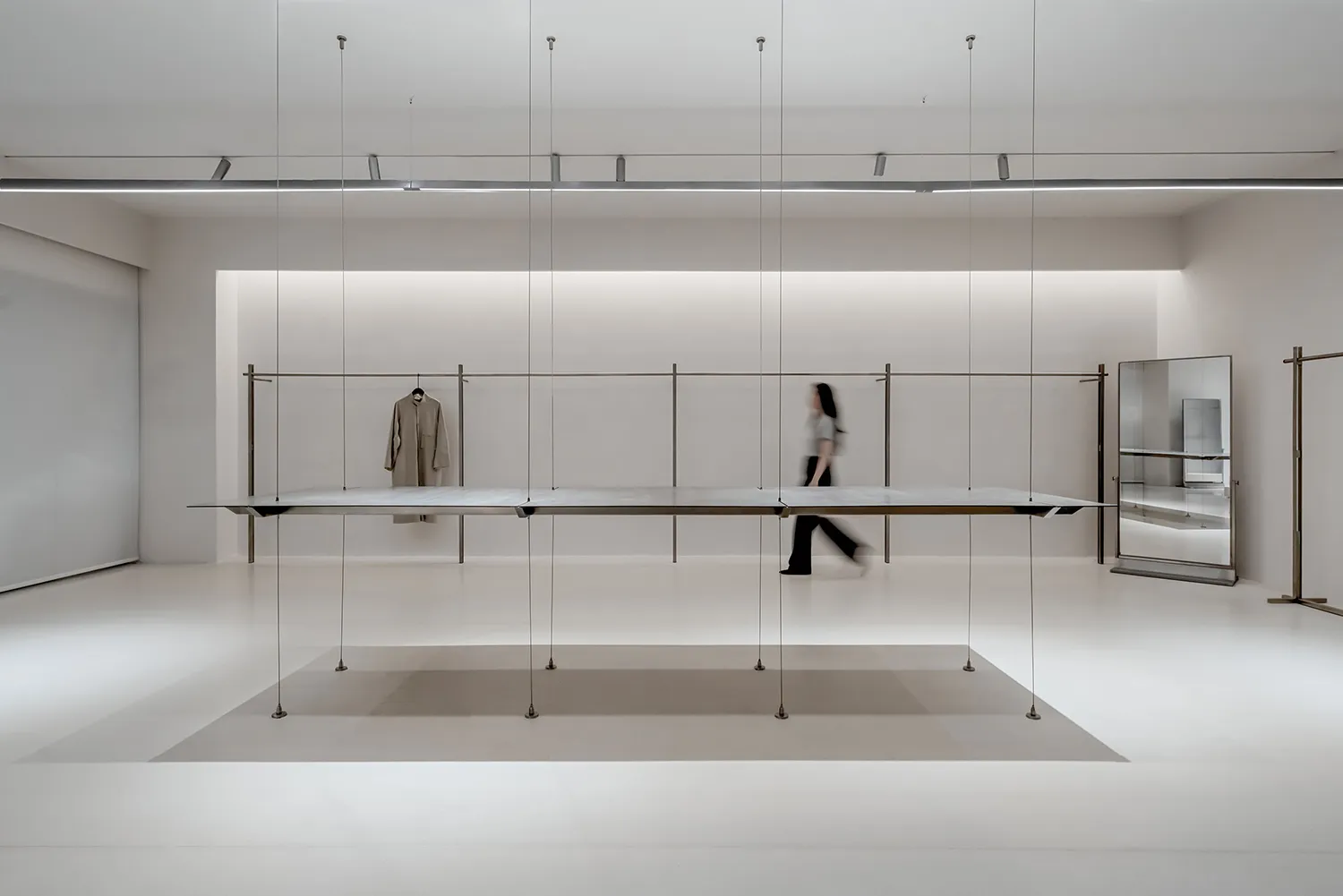 Modern minimalist commercial display featuring metallic elements on a white background.