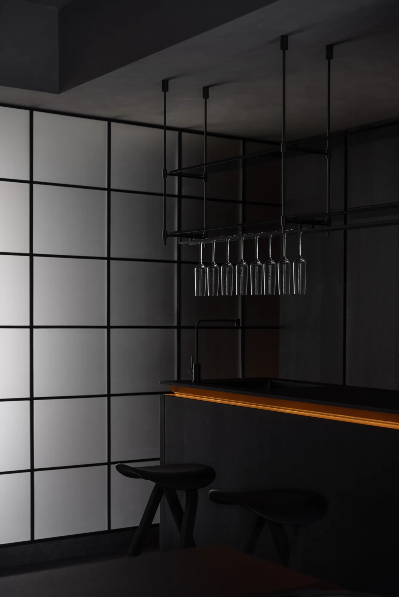A sleek, minimalist black bar counter with metallic accents.