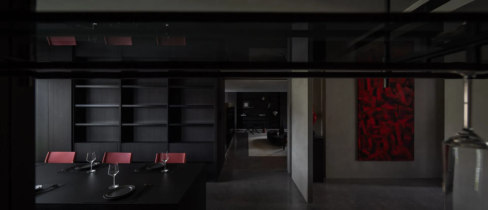 Modern dining room featuring dark wooden furniture and red accents