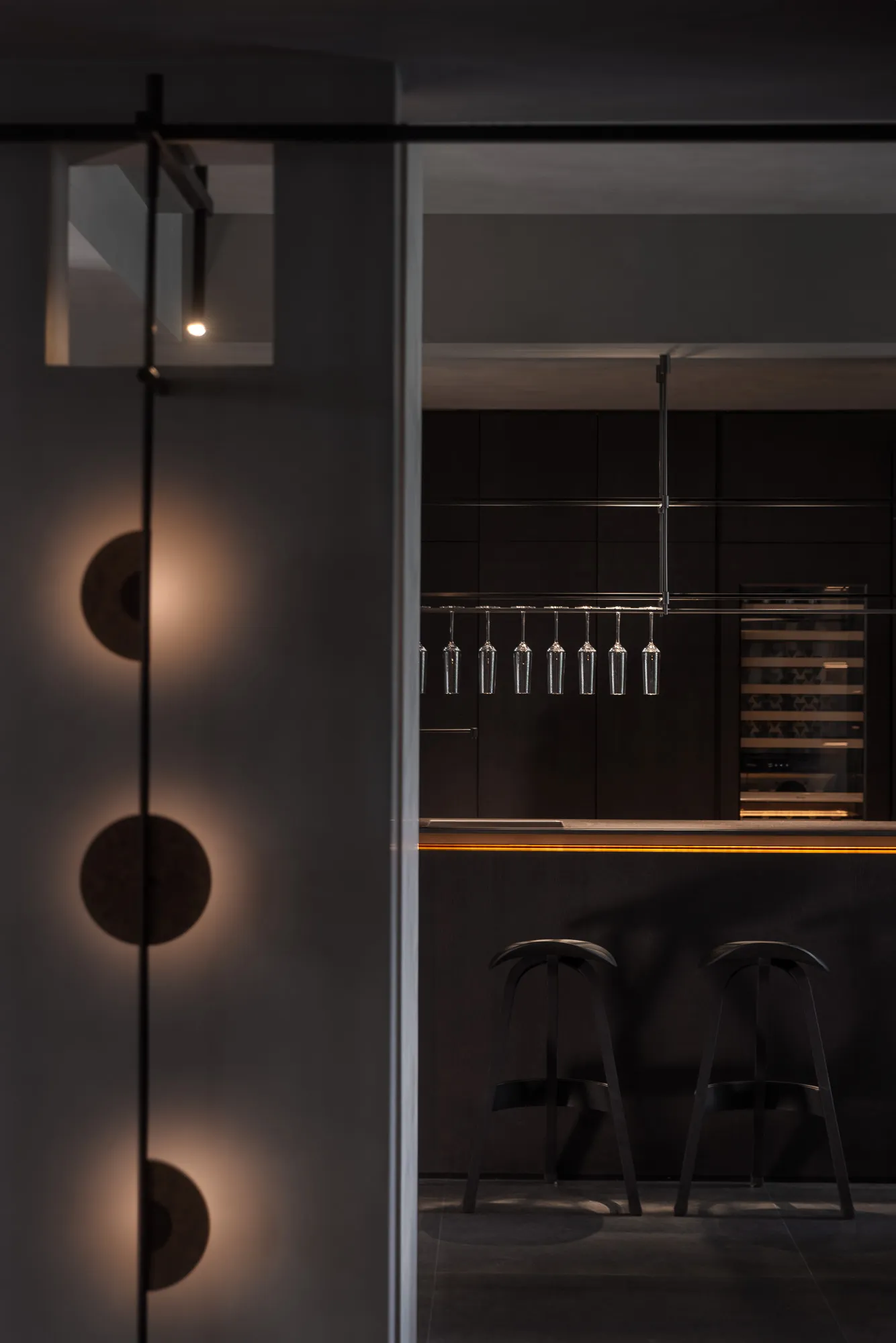 A modern kitchen with metallic finishes and minimalistic design.