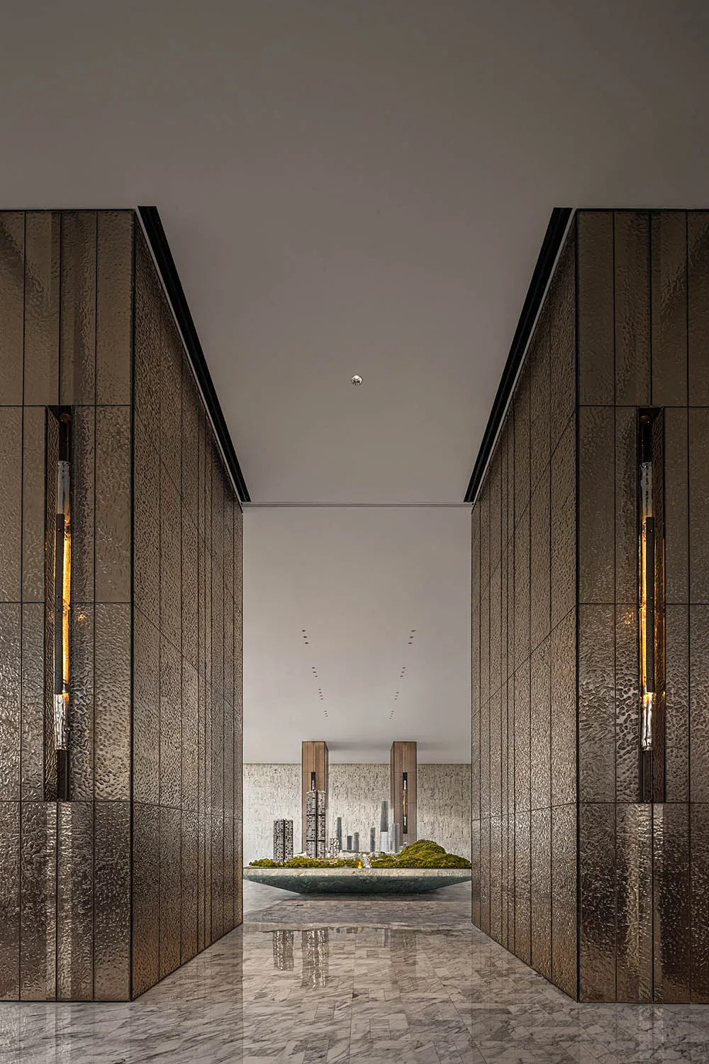 Modern lobby with metallic textured walls and marble flooring