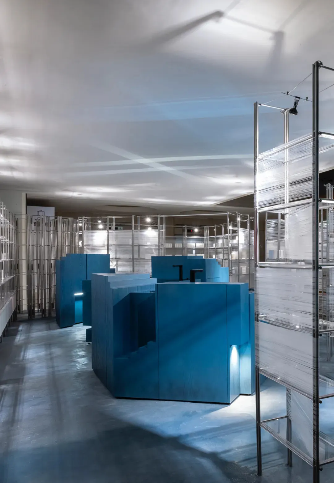 Modern retail space featuring blue retailing counters in a contemporary design.