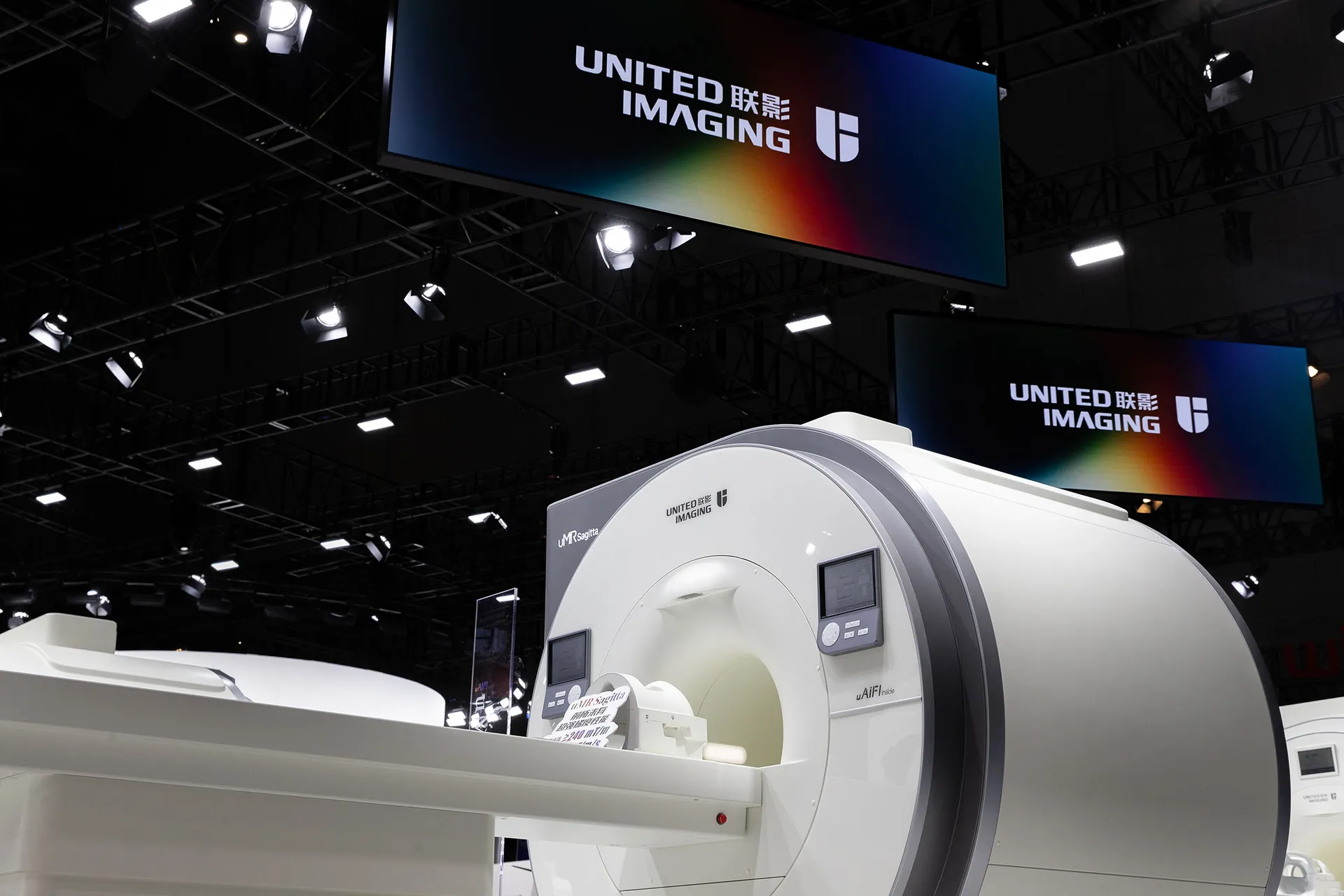 MRI scanner displayed at an exhibition with a focus on medical imaging technology.