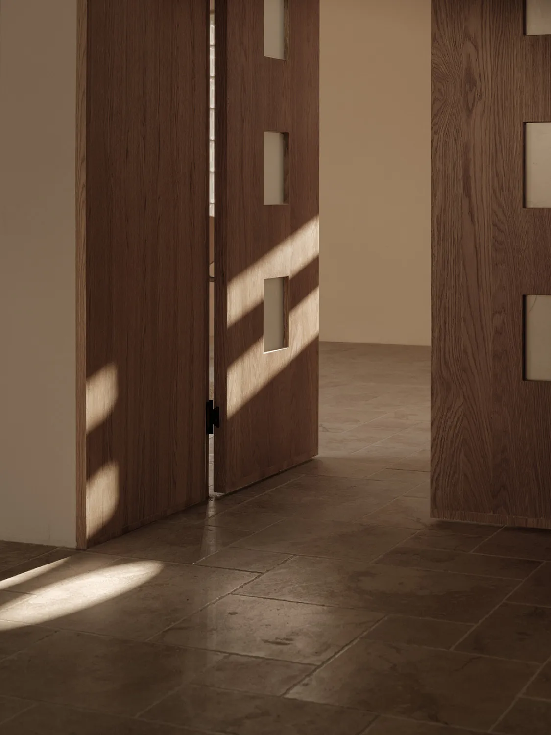 Minimalist room with brown wooden flooring, showing a modern, elegant design.