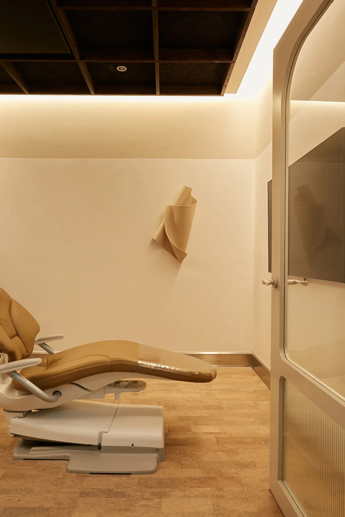 Modern dental office featuring a premium leather patient chair and minimalist design.
