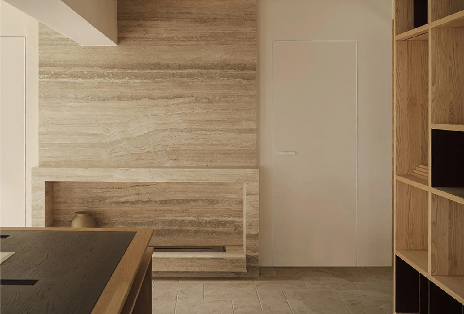 A modern kitchen featuring marble walls and a sleek, minimalist design.