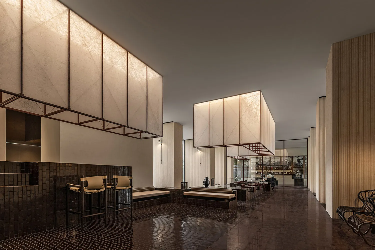 Modern restaurant interior with wooden walls, leather seating, and metallic accents.