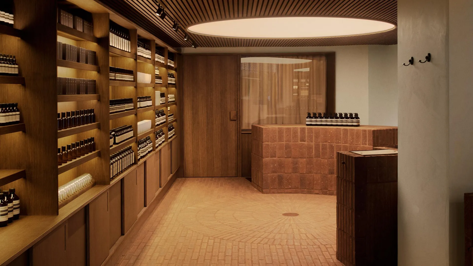 A modern retail storefront featuring exposed brick walls and wooden shelving.