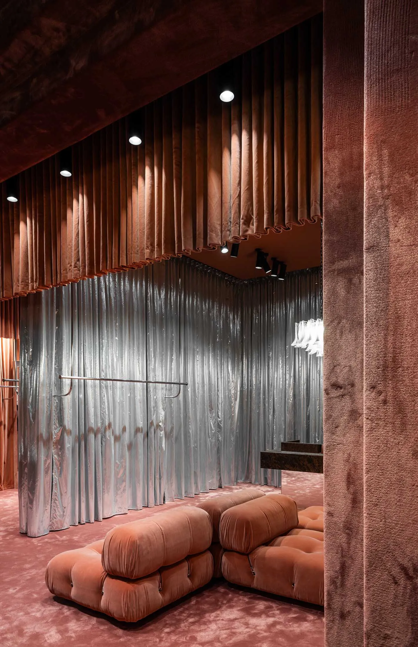 Modern, contemporary storefront with fabric panels, metal accents, and large glass windows.