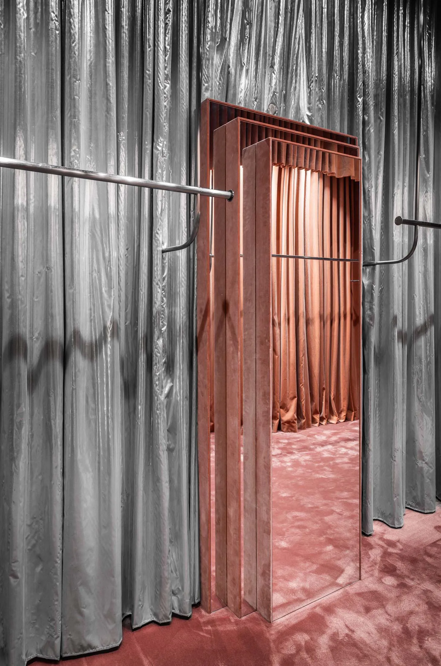 Modern fashion store interior with velvet rails and reflective surfaces