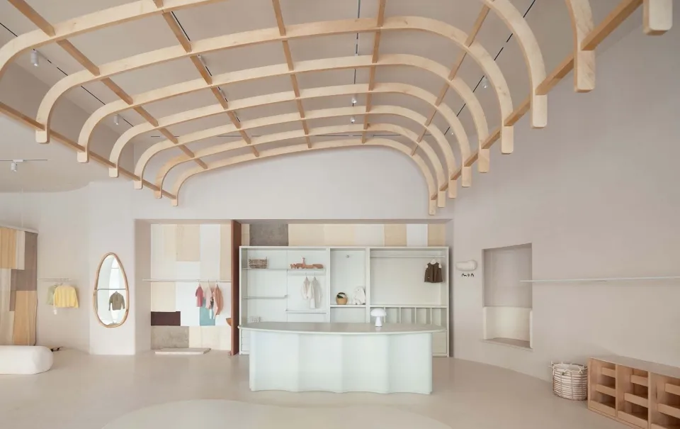 A minimalist retail space featuring a modern counter made of natural wood