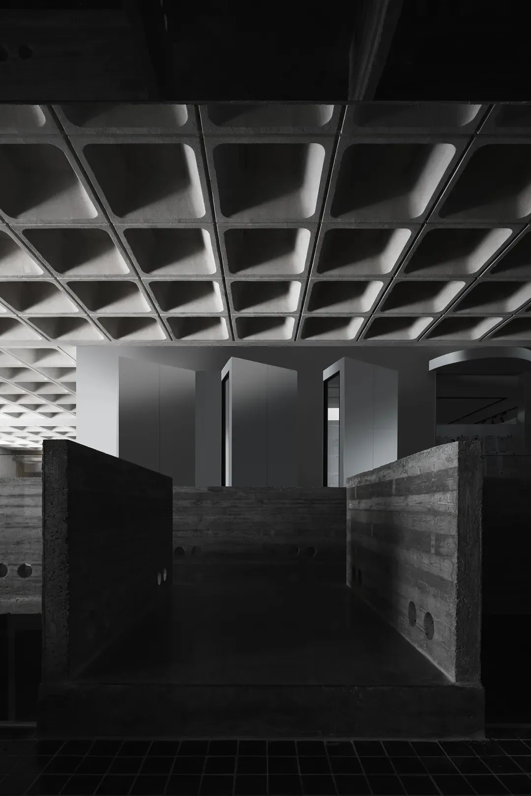 A contemporary office space featuring concrete and glass materials.