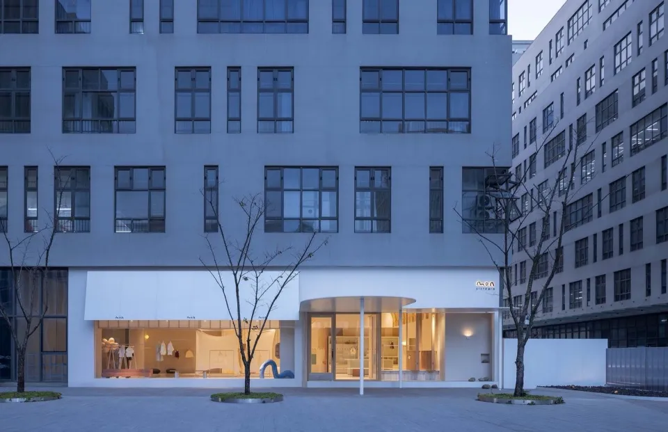 Modern storefront with glass walls and concrete materials.
